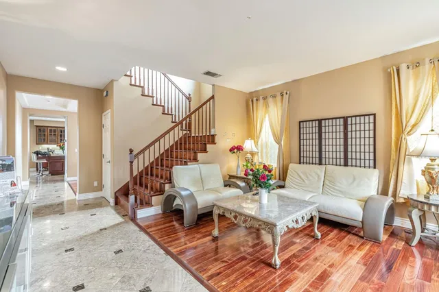 a living room with furniture and wooden floor