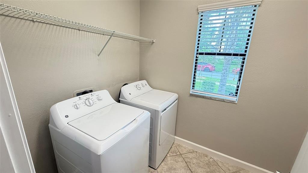 11017 Purple Martin Boulevard Riverview, FL 33579 - Photo 12 of 46 a utility room with dryer and washer