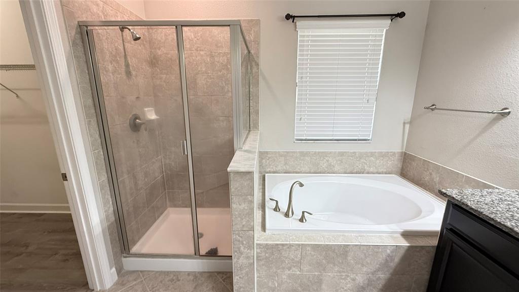 11017 Purple Martin Boulevard Riverview, FL 33579 - Photo 21 of 46 a bathroom with a bathtub and a shower