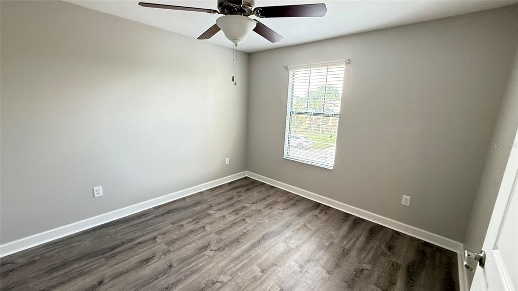 11017 Purple Martin Boulevard Riverview, FL 33579 - Photo 29 of 46 an empty room with a window and a fan