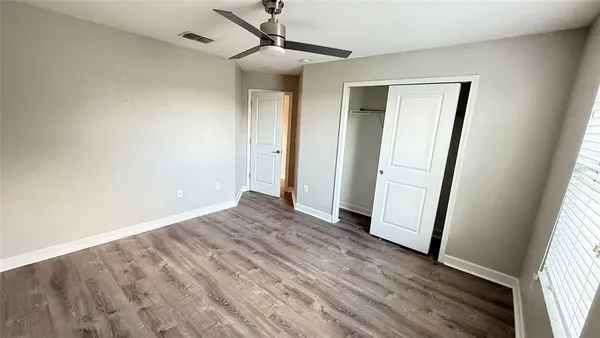 a bathroom with a granite countertop double vanity and a mirror