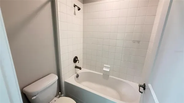 a view of a hallway with a couch and a window