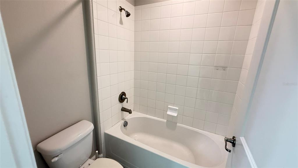 11017 Purple Martin Boulevard Riverview, FL 33579 - Photo 33 of 46 a white bath tub sitting next to a white toilet