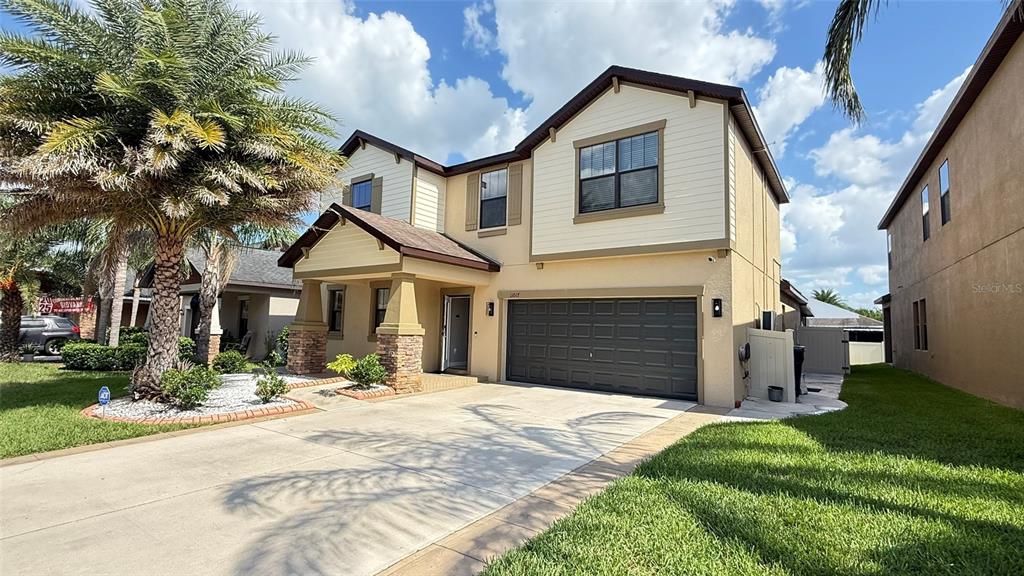 11017 Purple Martin Boulevard Riverview, FL 33579 - Photo 4 of 46 a front view of a house with a yard and garage