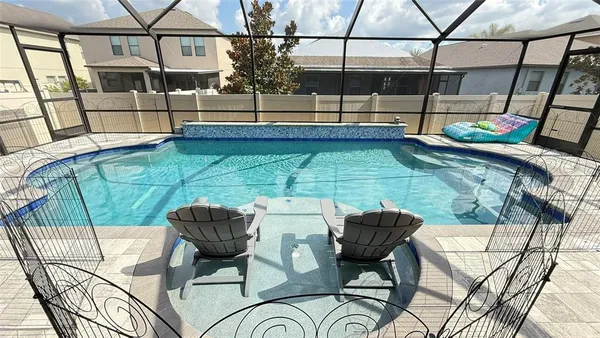 a view of swimming pool with seating area