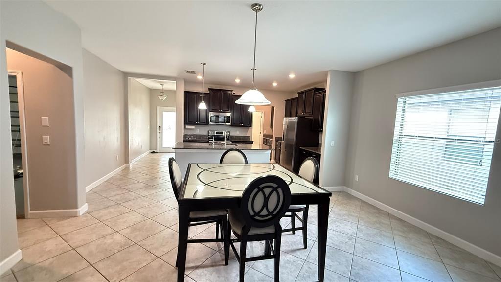 11017 Purple Martin Boulevard Riverview, FL 33579 - Photo 10 of 46 a dining room with furniture and window
