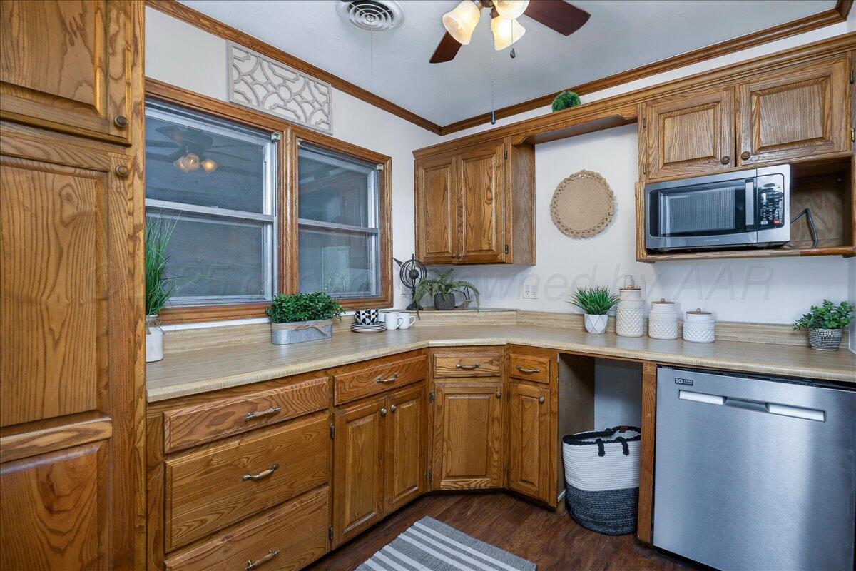 25701 Newton Road Canyon, TX 79015 - Photo 12 of 30 a kitchen with a sink cabinets and stainless steel appliances