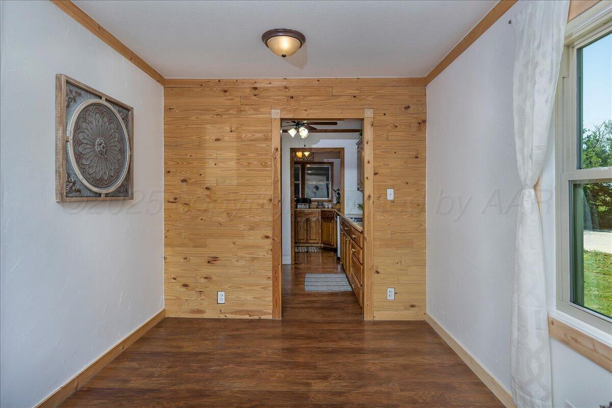 25701 Newton Road Canyon, TX 79015 - Photo 13 of 30 a view of a hallway with wooden floor and a window