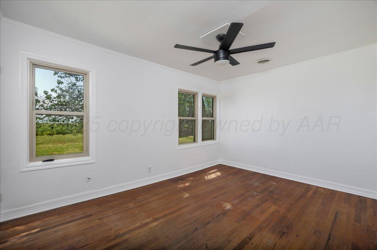 25701 Newton Road Canyon, TX 79015 - Photo 14 of 30 a view of a room with wooden floor and windows