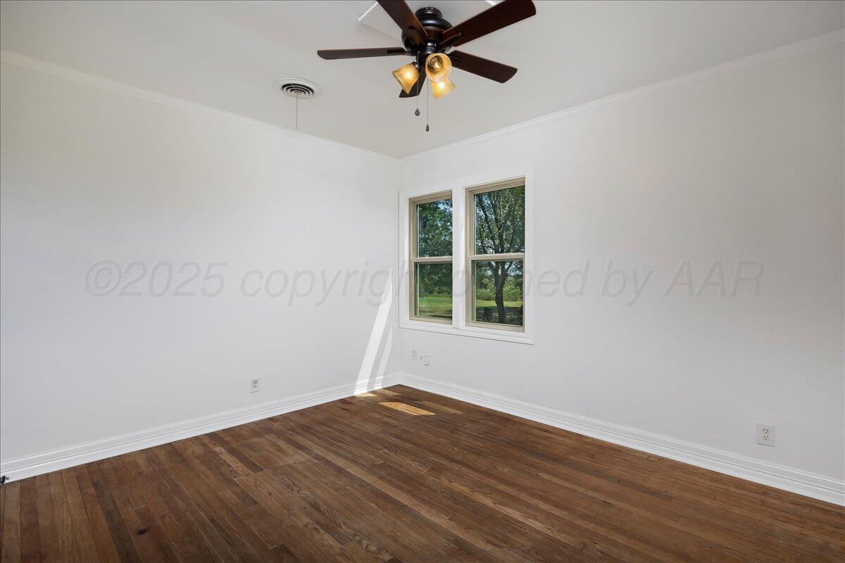 25701 Newton Road Canyon, TX 79015 - Photo 15 of 30 wooden floor in an empty room with a window