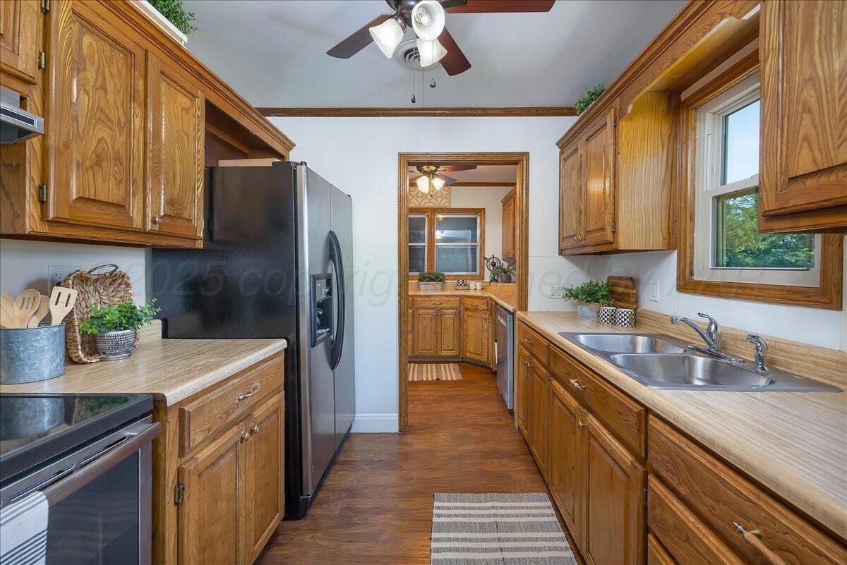 25701 Newton Road Canyon, TX 79015 - Photo 10 of 30 a kitchen with stainless steel appliances granite countertop a sink a stove and refrigerator