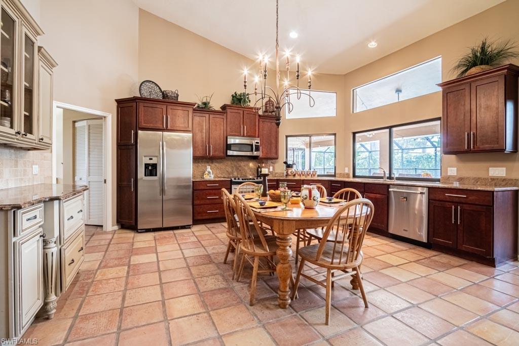 2209 Pinewoods Circle Naples, FL 34105 - Photo 11 of 46 a large kitchen with a table and chairs