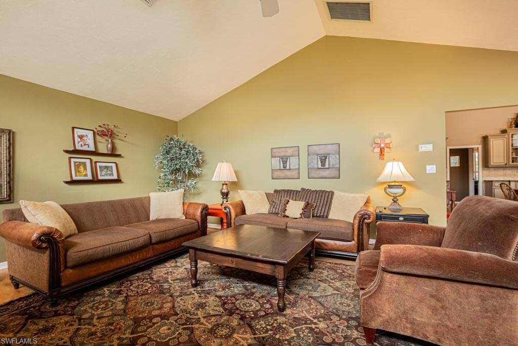 2209 Pinewoods Circle Naples, FL 34105 - Photo 15 of 46 a living room with furniture and a table