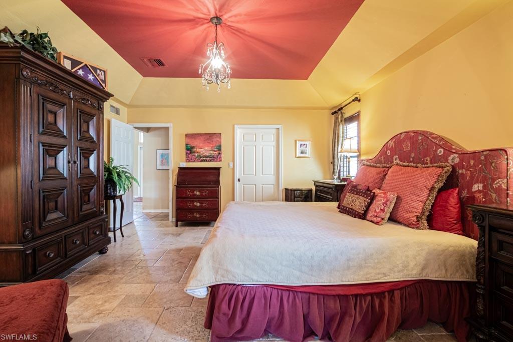 2209 Pinewoods Circle Naples, FL 34105 - Photo 19 of 46 a bedroom with a bed and a television