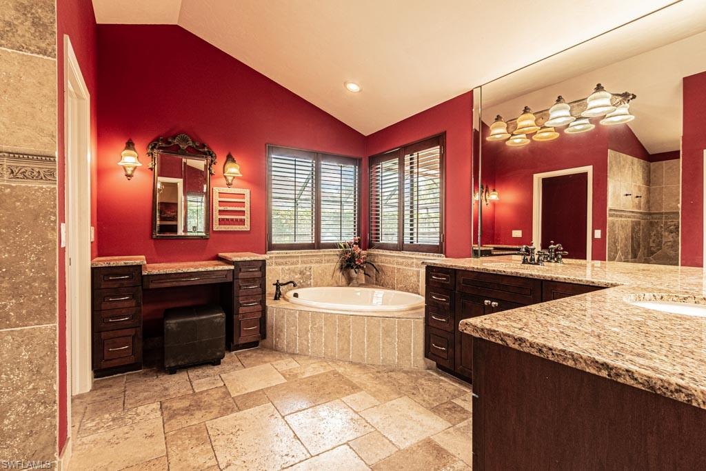 2209 Pinewoods Circle Naples, FL 34105 - Photo 20 of 46 a large bathroom with a sink and a large mirror