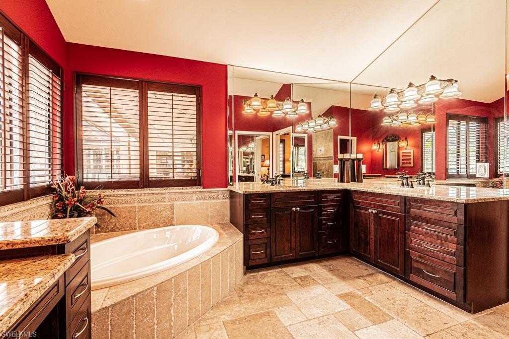 2209 Pinewoods Circle Naples, FL 34105 - Photo 21 of 46 a spacious bathroom with a granite countertop tub and a sink