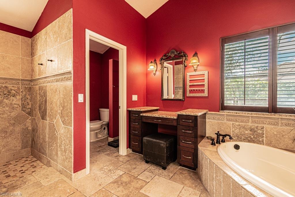 2209 Pinewoods Circle Naples, FL 34105 - Photo 22 of 46 a spacious bathroom with a bathtub sink and mirror
