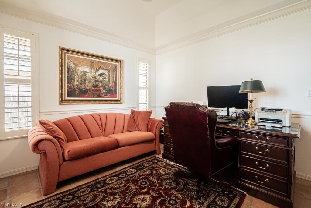 2209 Pinewoods Circle Naples, FL 34105 - Photo 24 of 46 a living room with furniture and a flat screen tv