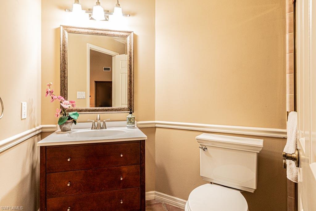 2209 Pinewoods Circle Naples, FL 34105 - Photo 25 of 46 a bathroom with a toilet a sink and mirror