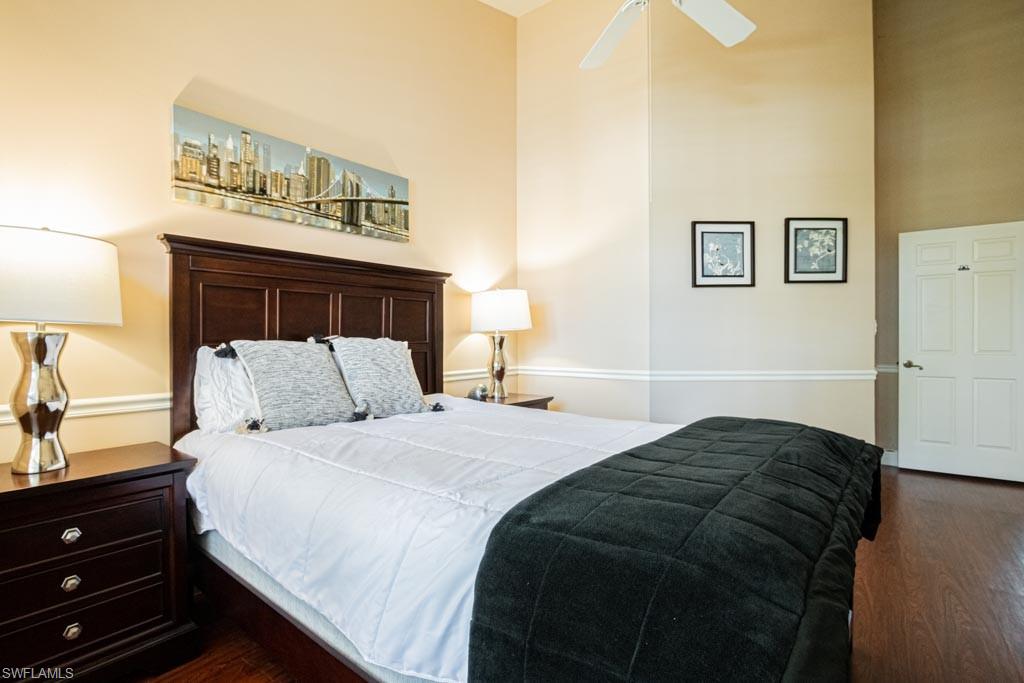 2209 Pinewoods Circle Naples, FL 34105 - Photo 28 of 46 a bedroom with a bed and a night stand