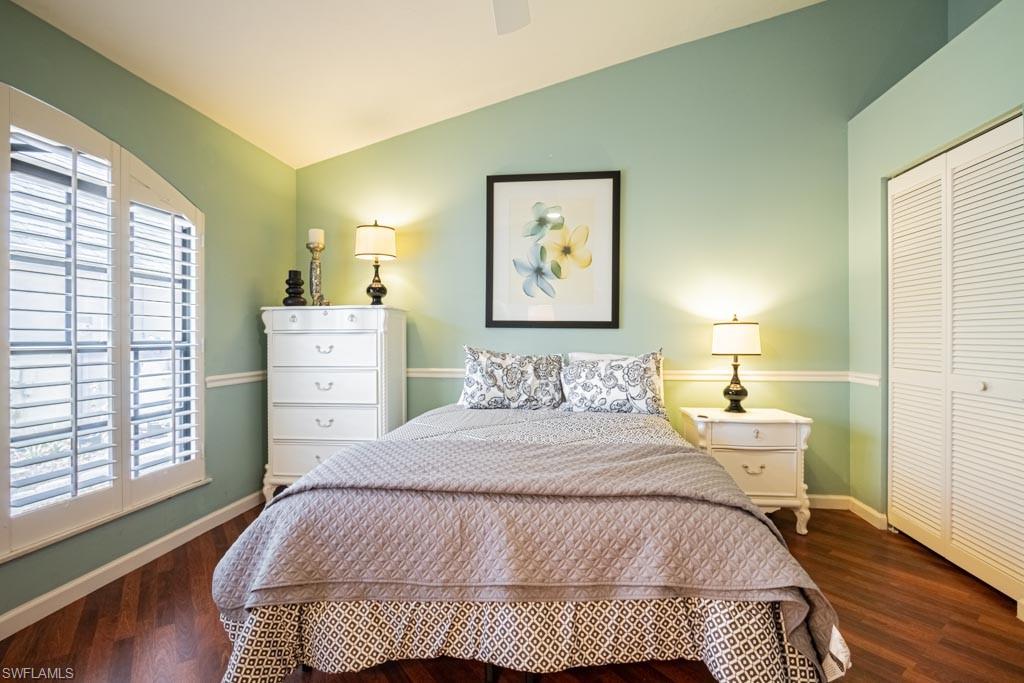 2209 Pinewoods Circle Naples, FL 34105 - Photo 30 of 46 a bedroom with a bed and wooden floor