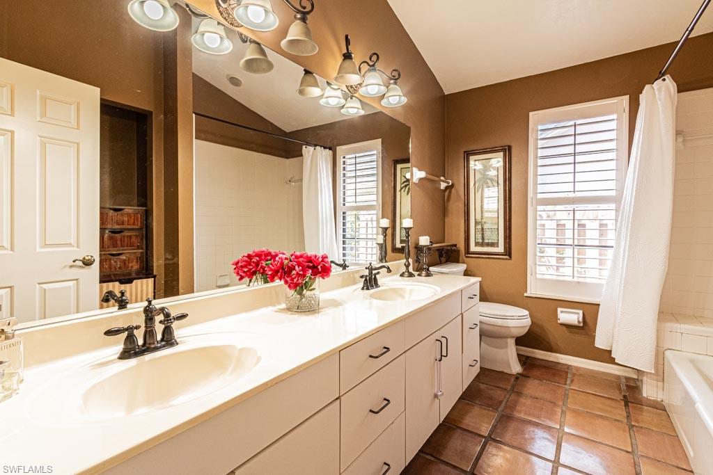 2209 Pinewoods Circle Naples, FL 34105 - Photo 33 of 46 a bathroom with a sink double vanity granite and a mirror