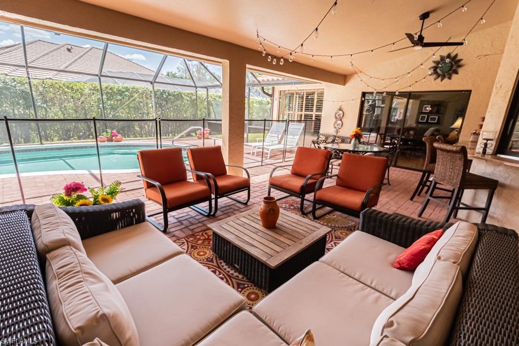2209 Pinewoods Circle Naples, FL 34105 - Photo 39 of 46 a living room with furniture and a floor to ceiling window