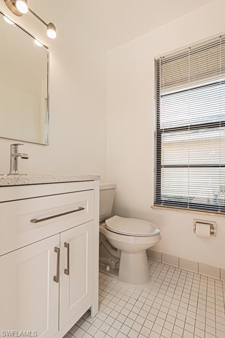 2209 Pinewoods Circle Naples, FL 34105 - Photo 40 of 46 a bathroom with a toilet sink and mirror