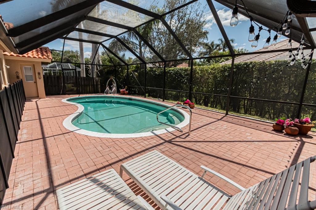 2209 Pinewoods Circle Naples, FL 34105 - Photo 41 of 46 a view of a swimming pool with a patio