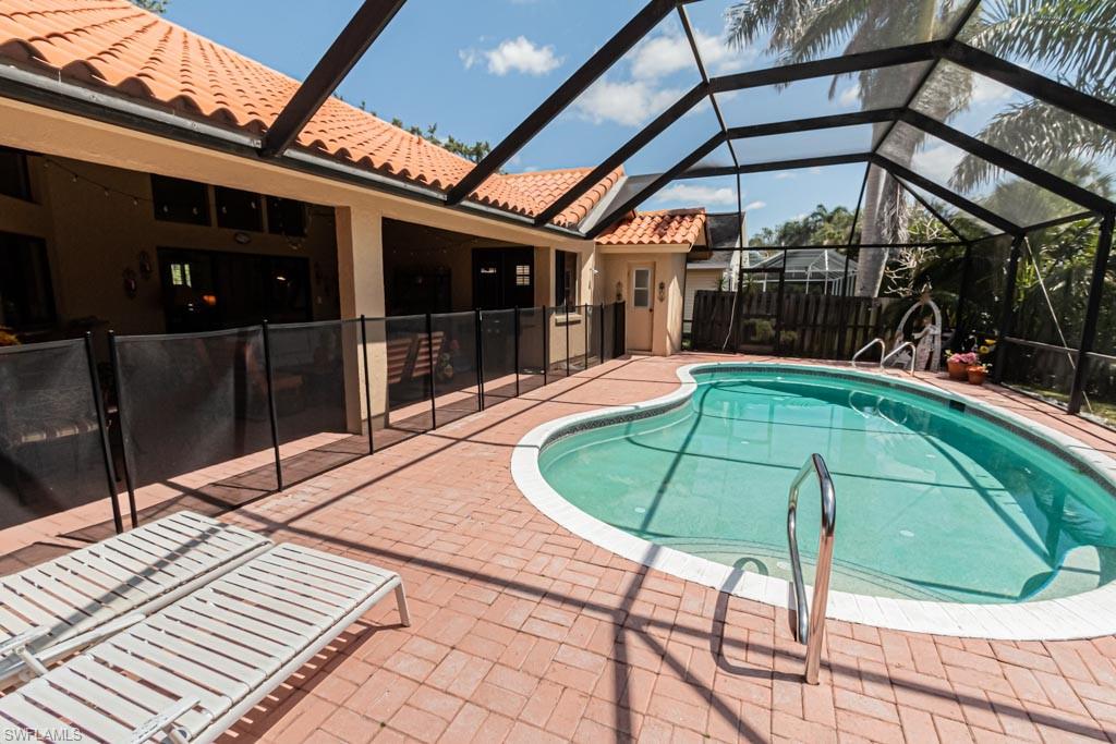 2209 Pinewoods Circle Naples, FL 34105 - Photo 42 of 46 a view of a chairs and table in the patio
