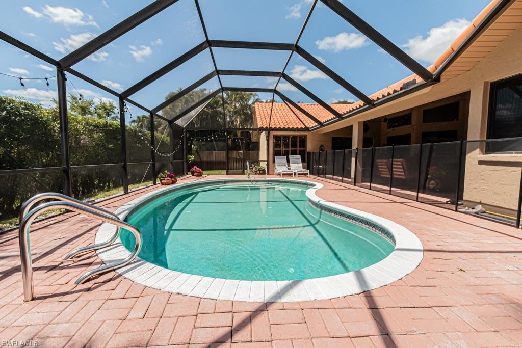 2209 Pinewoods Circle Naples, FL 34105 - Photo 43 of 46 a view of a swimming pool with a patio and a backyard
