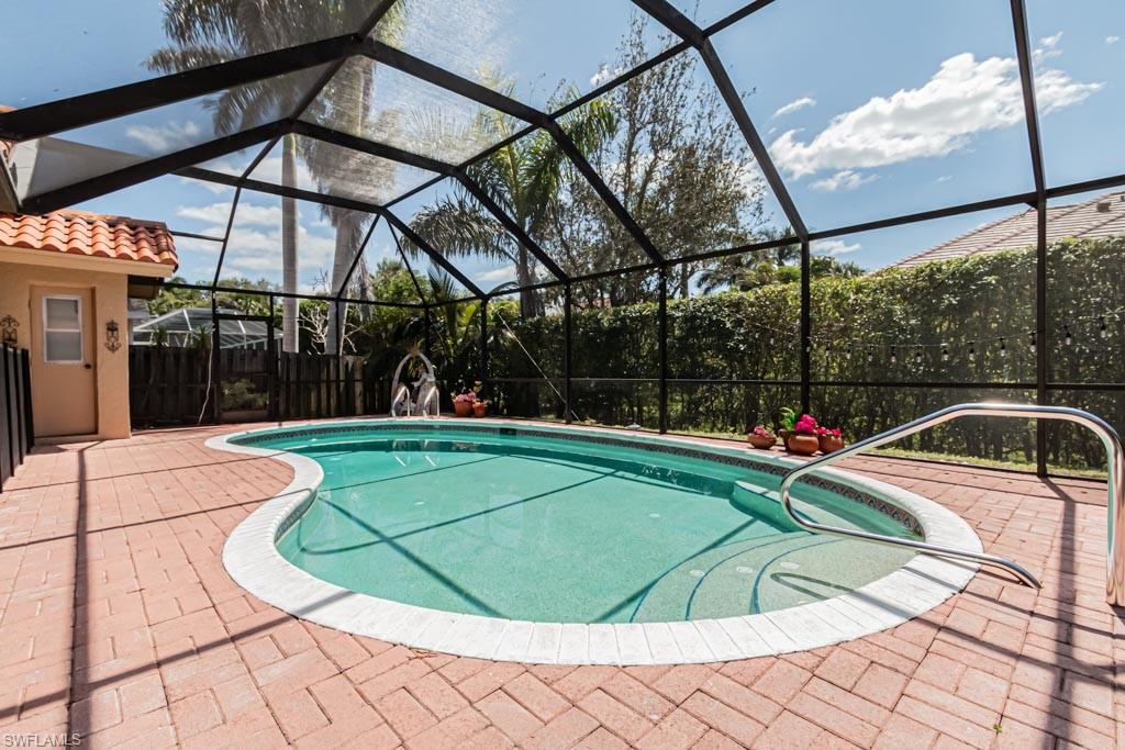 2209 Pinewoods Circle Naples, FL 34105 - Photo 44 of 46 a view of a swimming pool with a yard in front of it