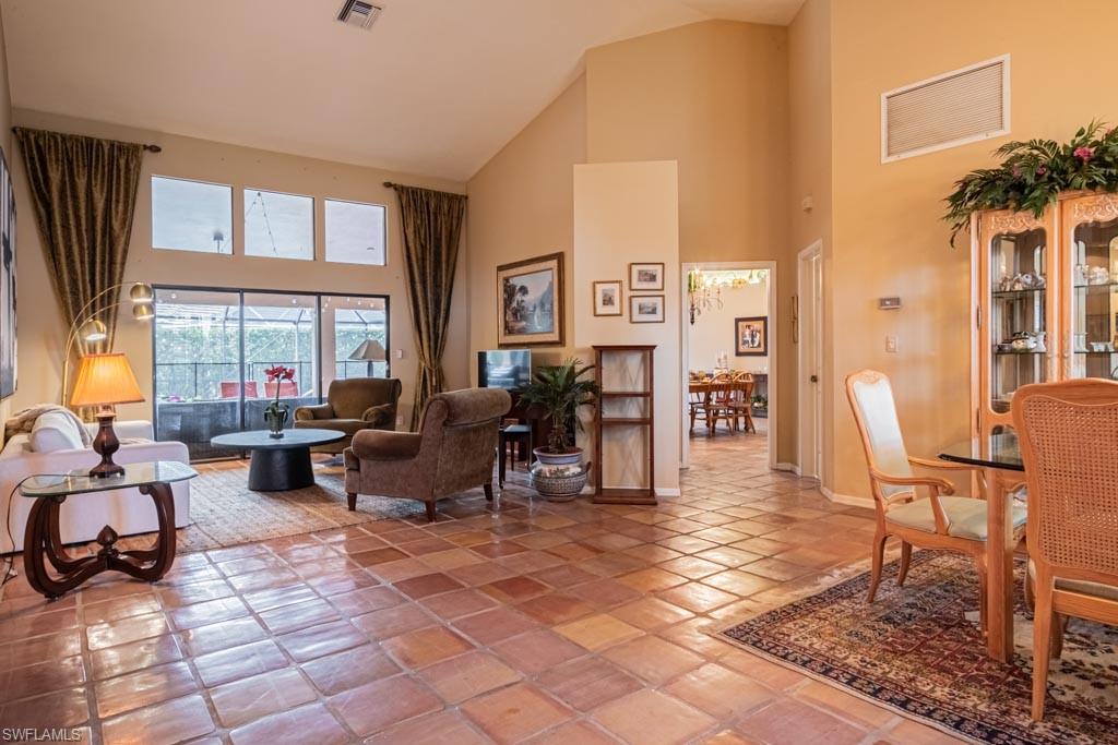 2209 Pinewoods Circle Naples, FL 34105 - Photo 5 of 46 a living room with furniture large window and a table
