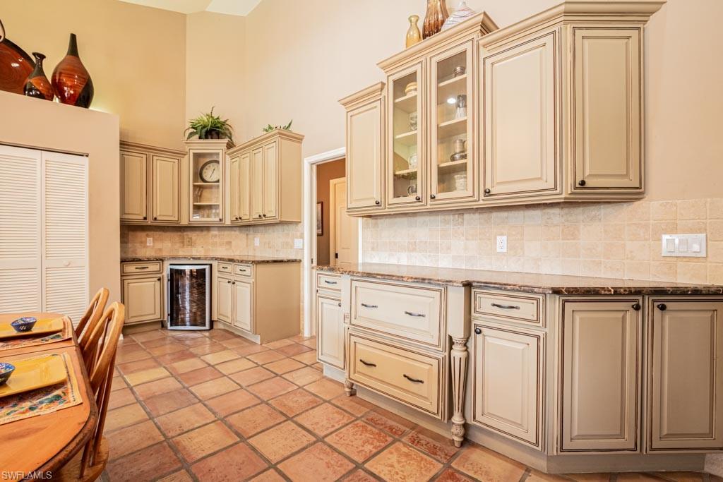 2209 Pinewoods Circle Naples, FL 34105 - Photo 9 of 46 a kitchen with stainless steel appliances granite countertop a stove and a white cabinets