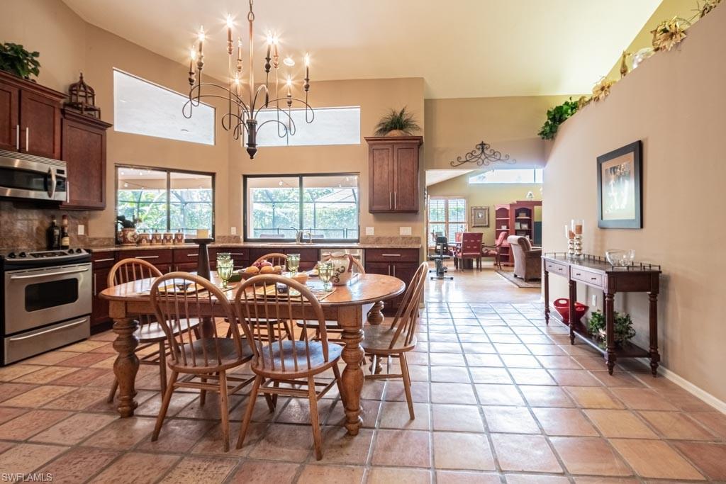 2209 Pinewoods Circle Naples, FL 34105 - Photo 10 of 46 a view of a dining room with furniture