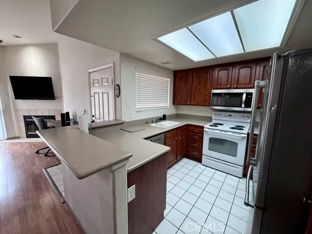 a kitchen with a stove a sink and a microwave