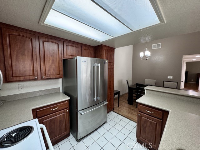 42140 Lyndie Lane, Unit 24 Temecula, CA 92591 - Photo 14 of 35 a kitchen with a refrigerator and a sink
