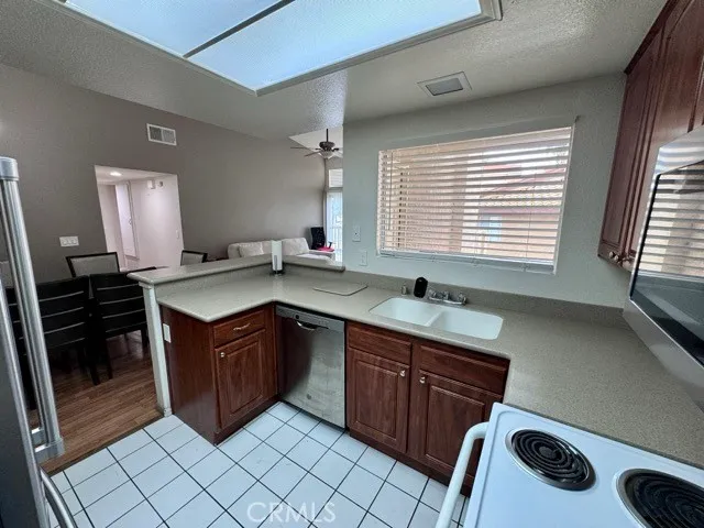 a kitchen with a sink stove and cabinets