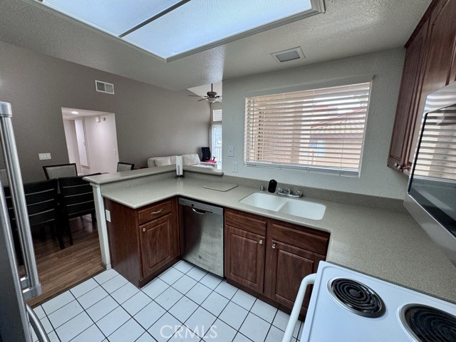 42140 Lyndie Lane, Unit 24 Temecula, CA 92591 - Photo 15 of 35 a kitchen with a sink stove and cabinets