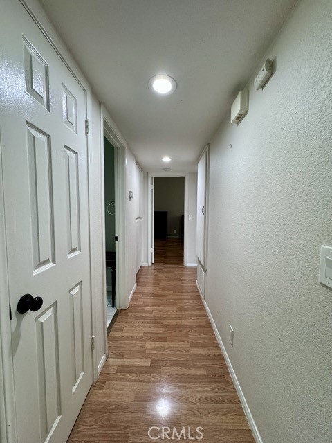 42140 Lyndie Lane, Unit 24 Temecula, CA 92591 - Photo 16 of 35 a view of a hallway with wooden floor and stairs