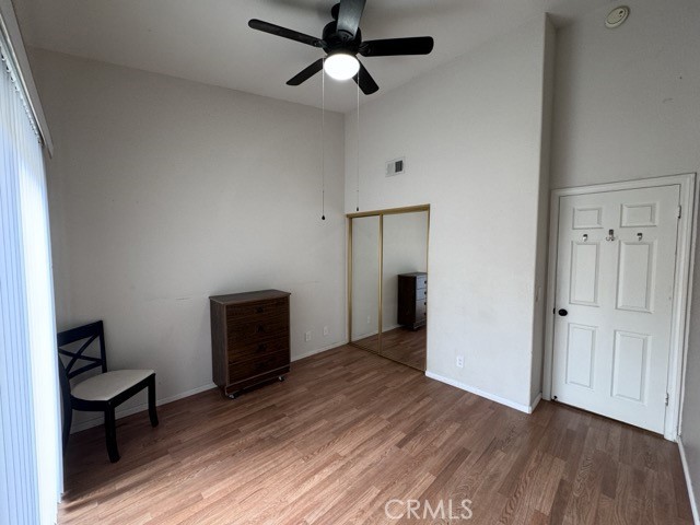 42140 Lyndie Lane, Unit 24 Temecula, CA 92591 - Photo 20 of 35 an empty room with wooden floor a ceiling fan and windows