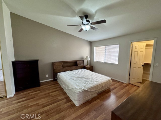 42140 Lyndie Lane, Unit 24 Temecula, CA 92591 - Photo 21 of 35 a bedroom with a bed and wooden floor