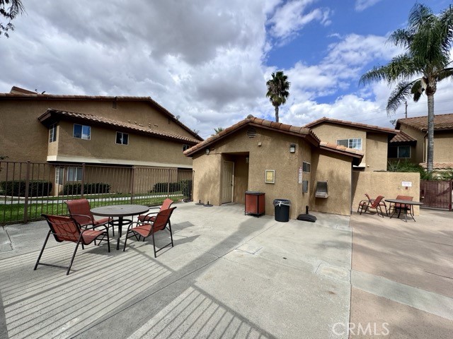 42140 Lyndie Lane, Unit 24 Temecula, CA 92591 - Photo 34 of 35 a view of a roof deck with table and chairs under an umbrella