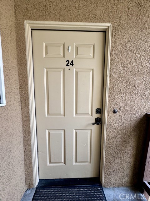 42140 Lyndie Lane, Unit 24 Temecula, CA 92591 - Photo 4 of 35 a view of a hallway with wooden floor and staircase