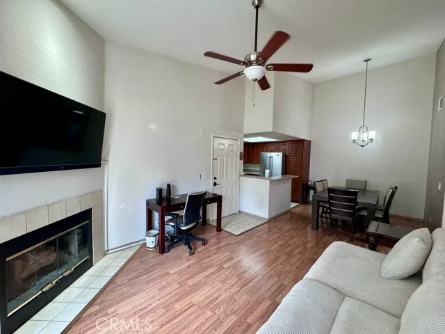 a living room with furniture a fireplace and a flat screen tv