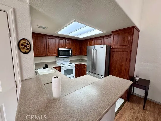 a kitchen with stainless steel appliances a refrigerator stove microwave and sink