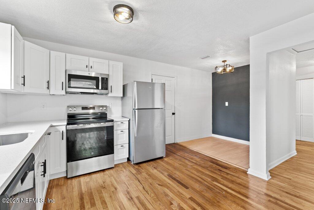 2389 Hilly Road Jacksonville, FL 32208 - Photo 10 of 35 Kitchen + Dining Area