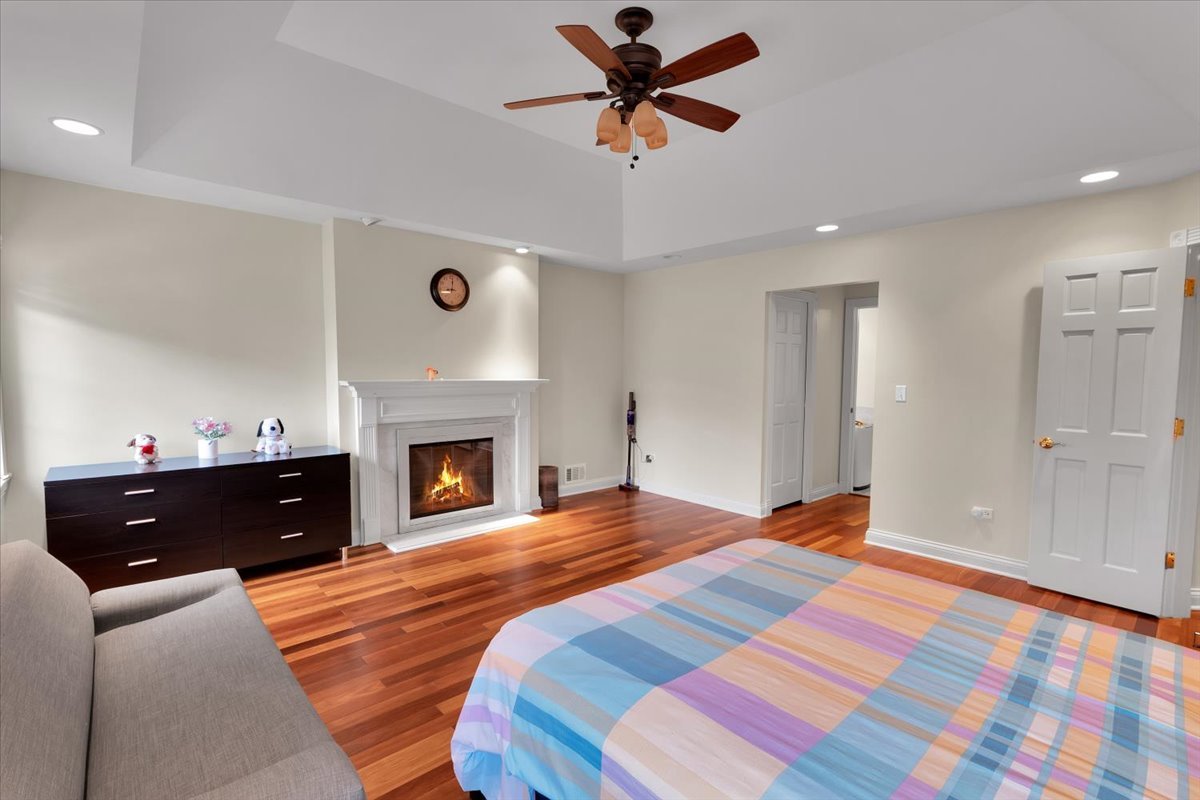 310 North County Line Road Hinsdale, IL 60521 - Photo 18 of 43 a bedroom with a bed and a fireplace