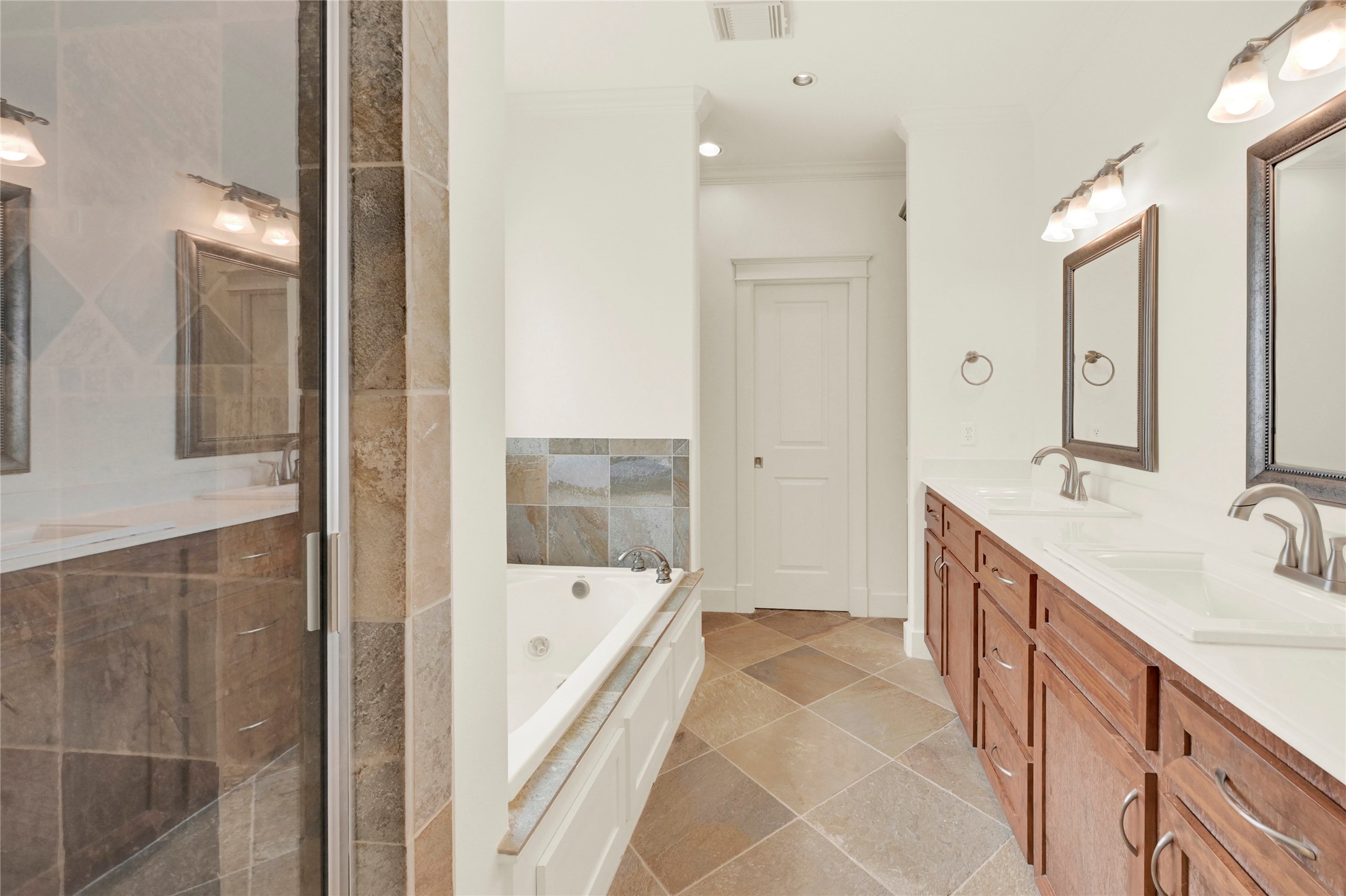 4418 Edsee Street Houston, TX 77009 - Photo 17 of 28 Step inside the primary bathroom and discover ultimate comfort with dual sinks, a jetted tun and separate walk-in shower.