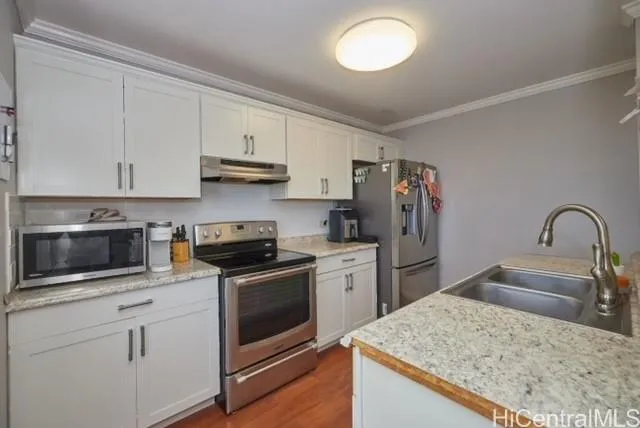 a kitchen with stainless steel appliances granite countertop a stove top oven a sink and dishwasher